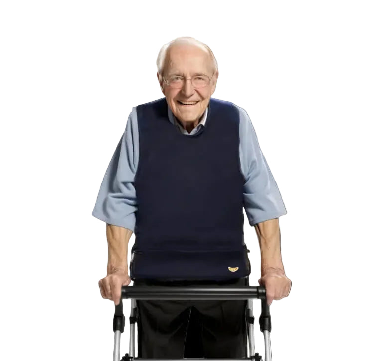 Smiling senior man in a blue, sleeveless Apri special needs bib. Stylish, waterproof clothing protector for adult dignity.